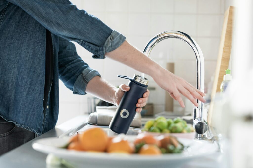 Water bottle being filled at home